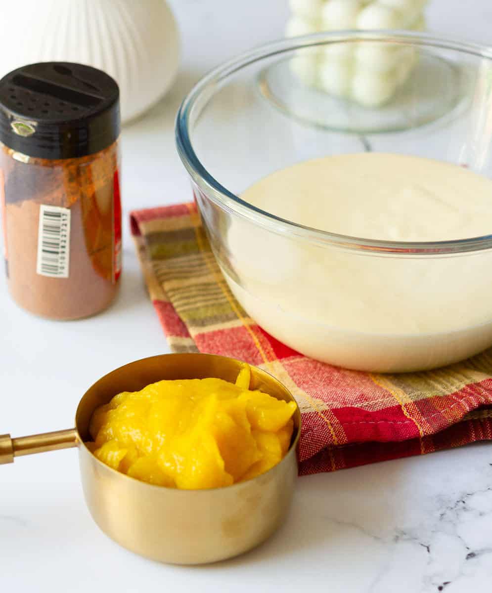 pumpkin puree, pumpkin pie spice, plain cheesecake batter in a small bowl