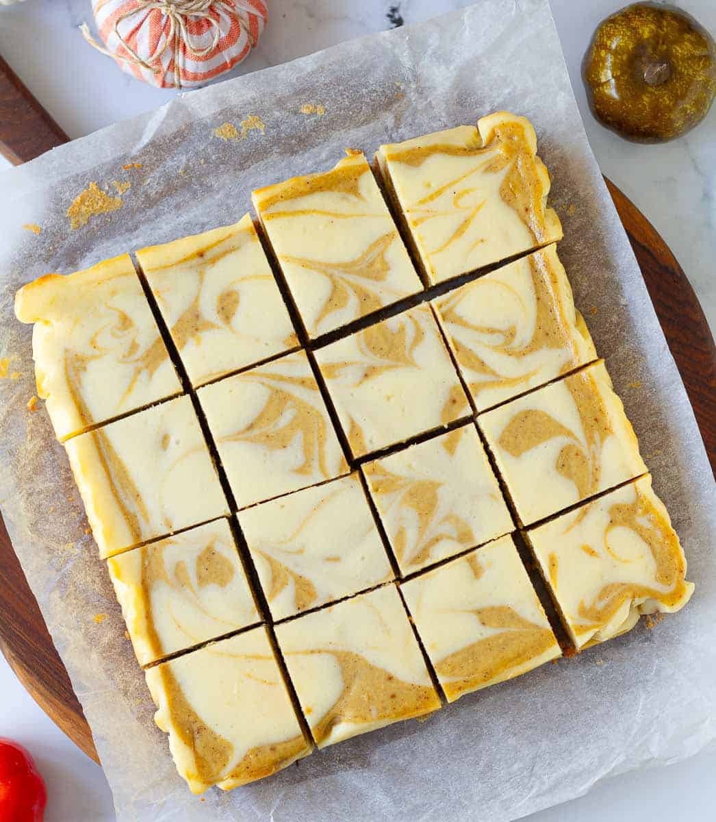 Pumpkin Swirl Cheesecake Bars cut into squares