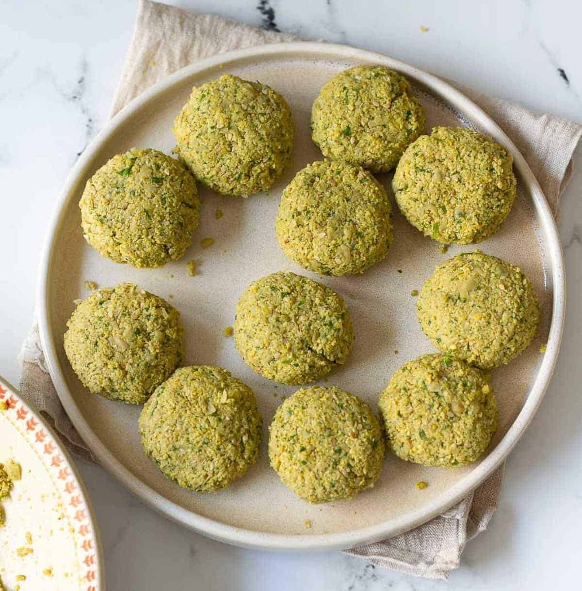 shaped falafel patties on a plate.