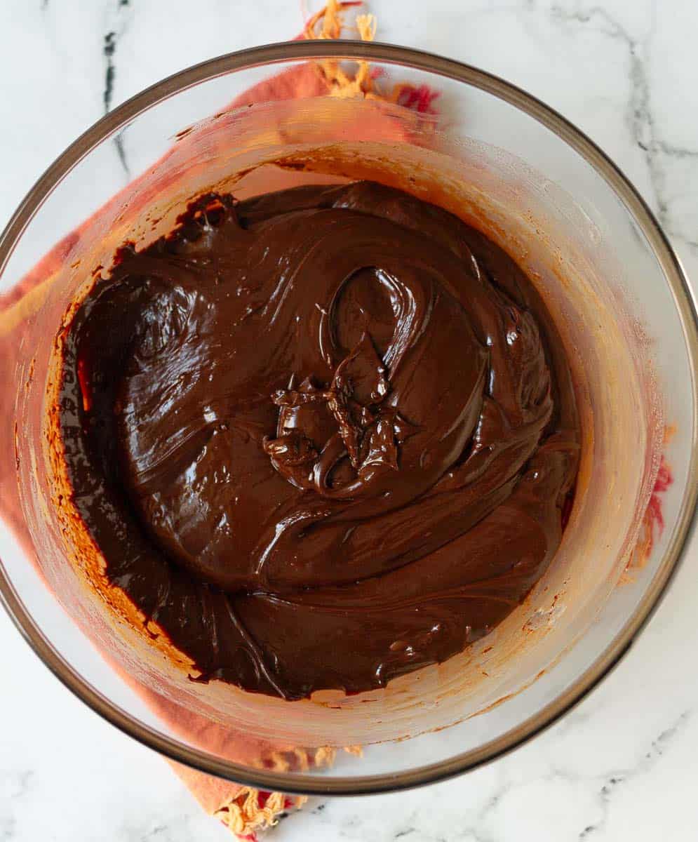 Melted chocolate, butter, and condensed milk mixture in a mixing bowl.