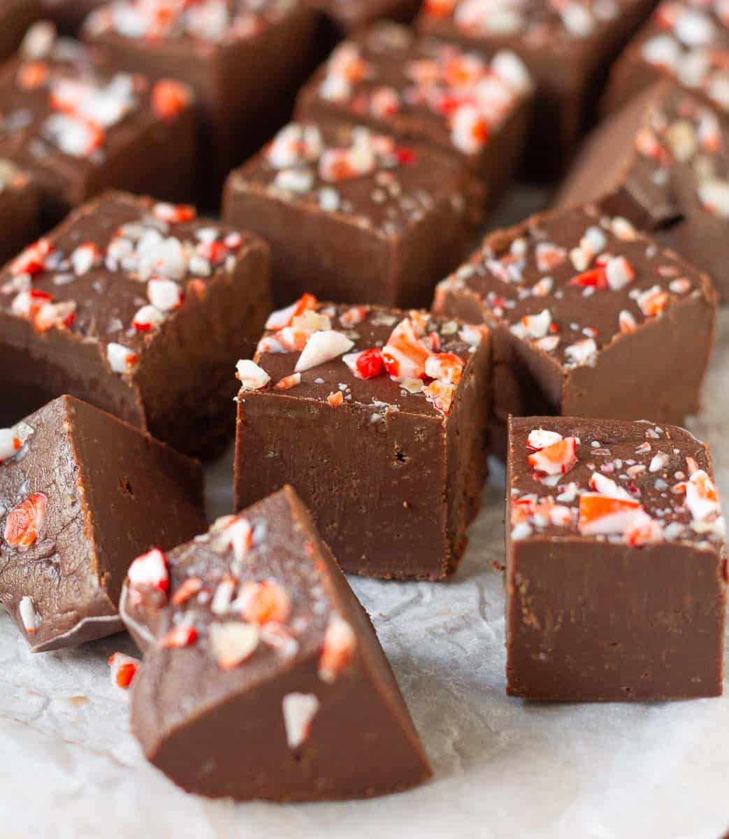 Chocolate fudge squares on parchment paper.