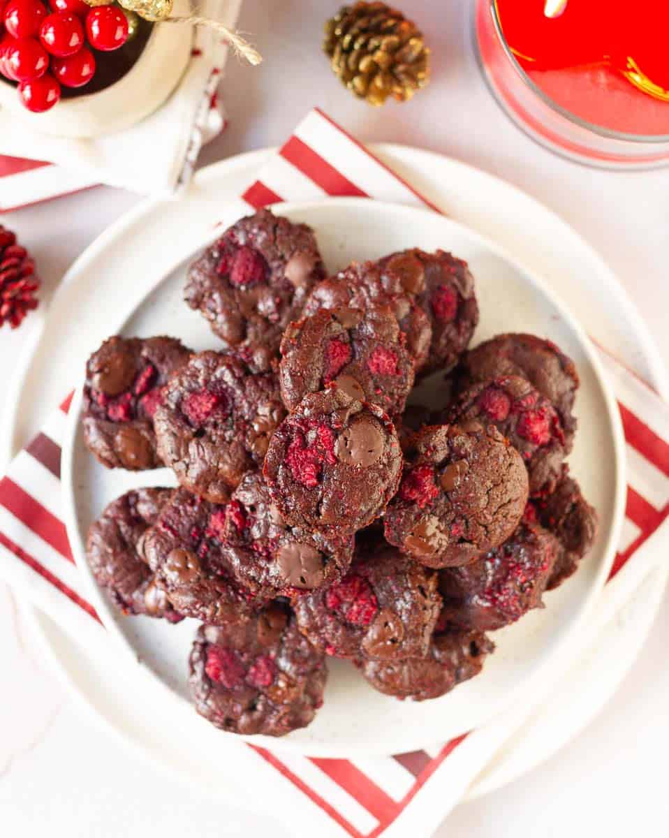 Chocolate brownies with raspberries on a platter.