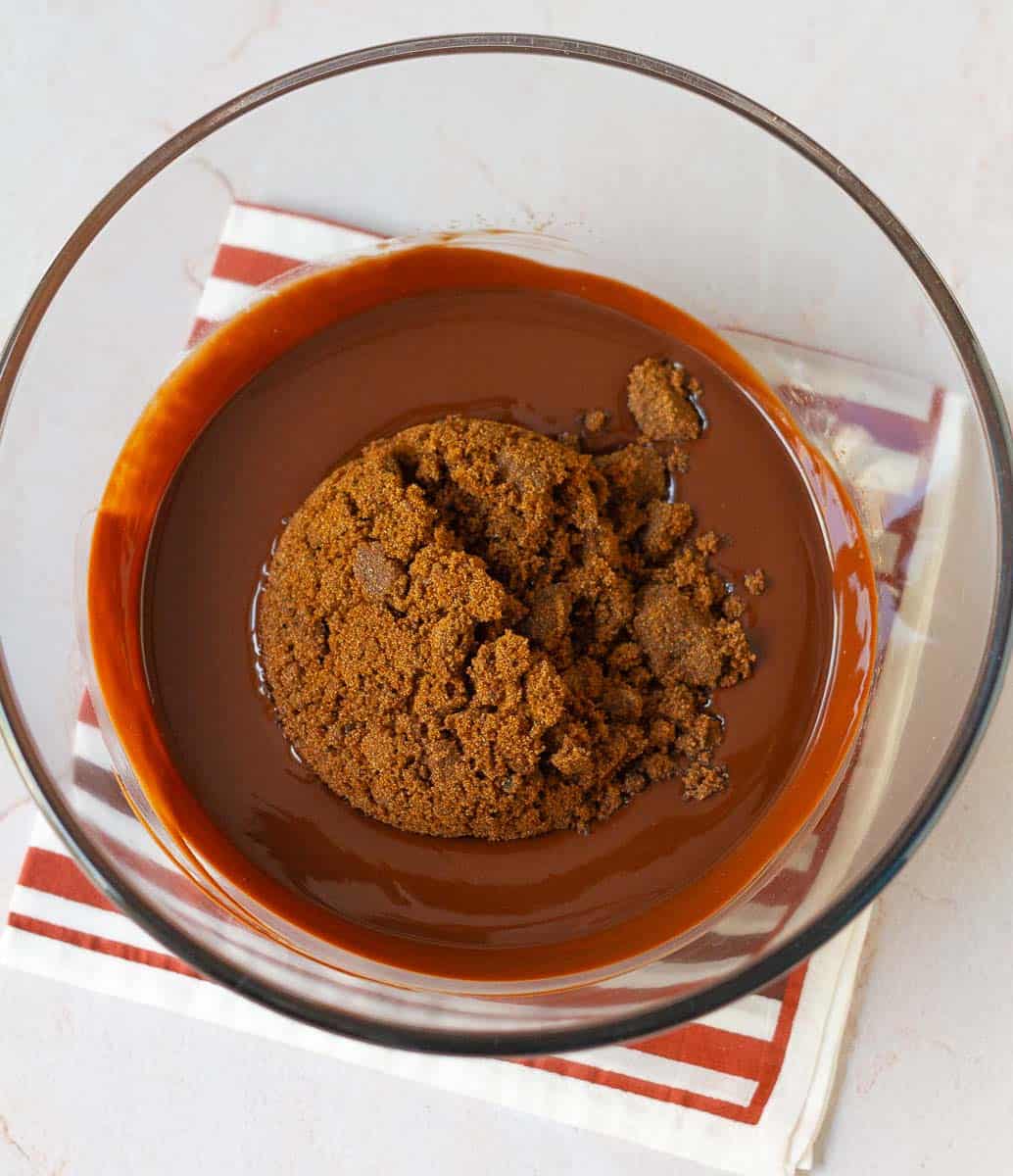 mixing sugar in melted butter chocolate mixture.