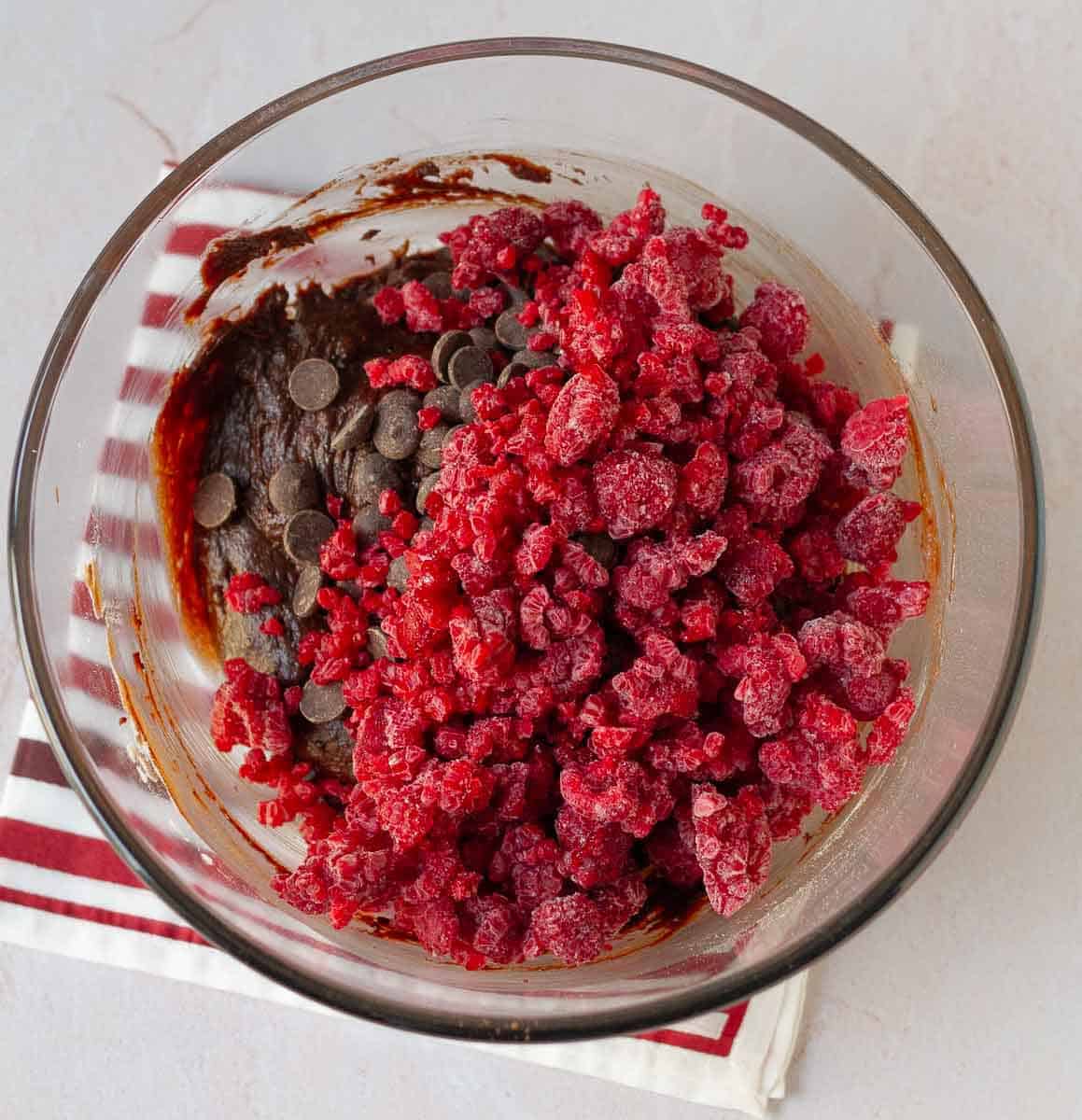 chocolate chips and frozen raspberries on the brownie batter.