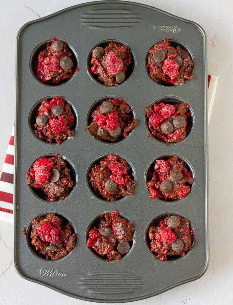 Brownie batter in a mini muffin tray.