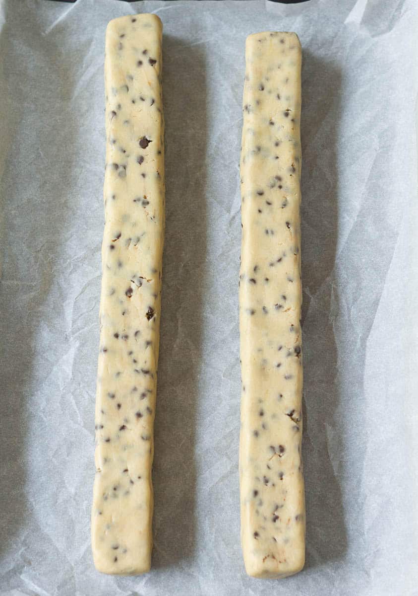 cookie dough divided in half and rolled into logs.