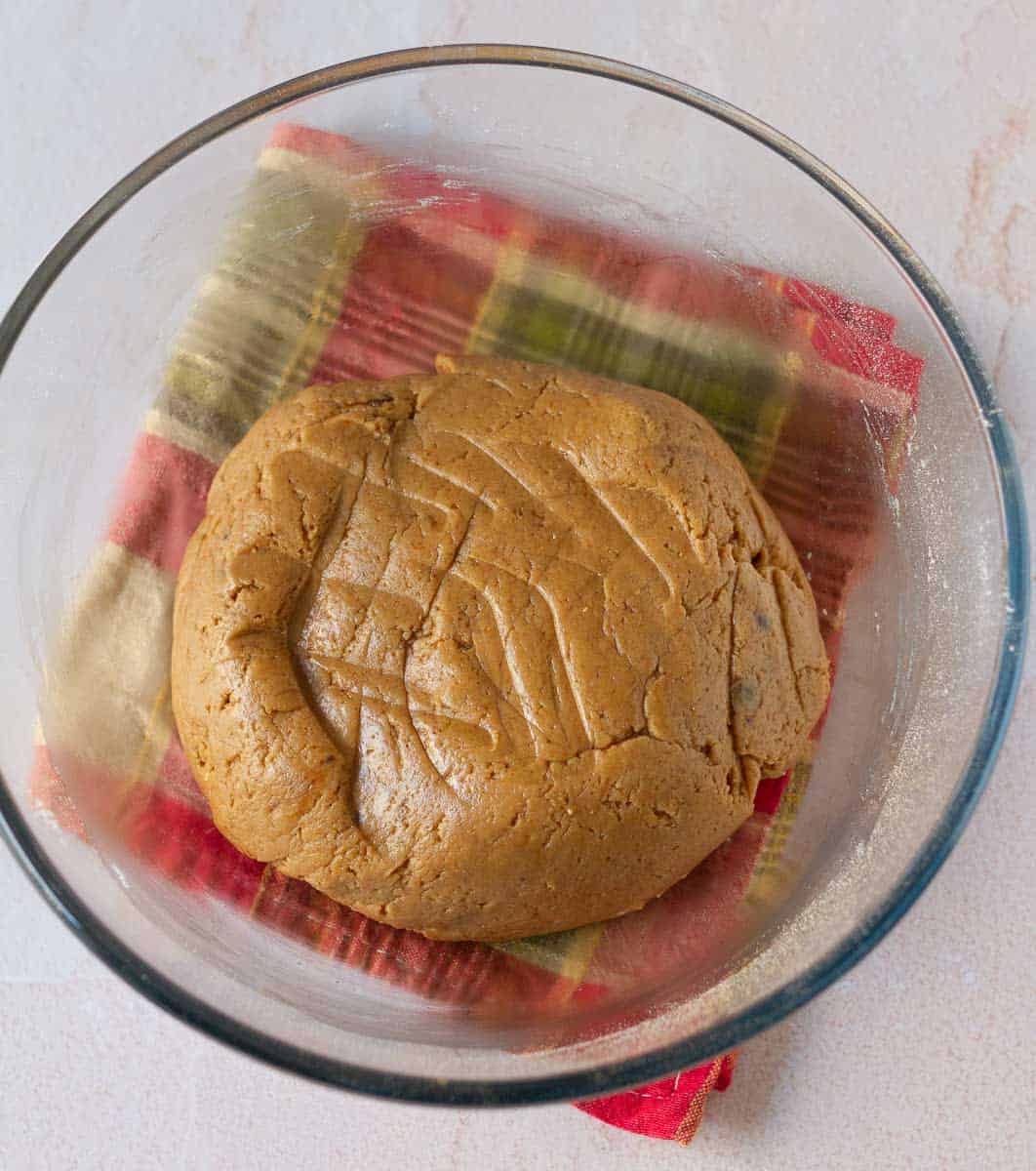 Dough for the gingerbread crinkle cookies in a glass bowl