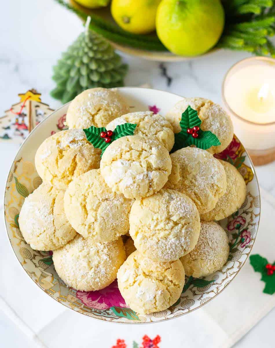 Crinkle cookies on a serving plate with Christmas decorations around.