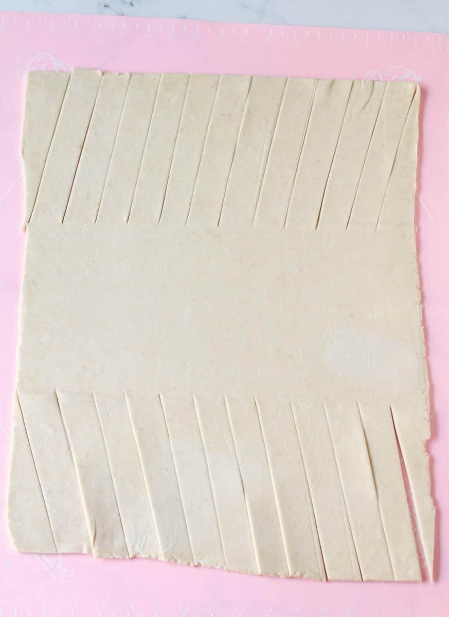 Ends of the rolled out pastry cut into diagonal strips.