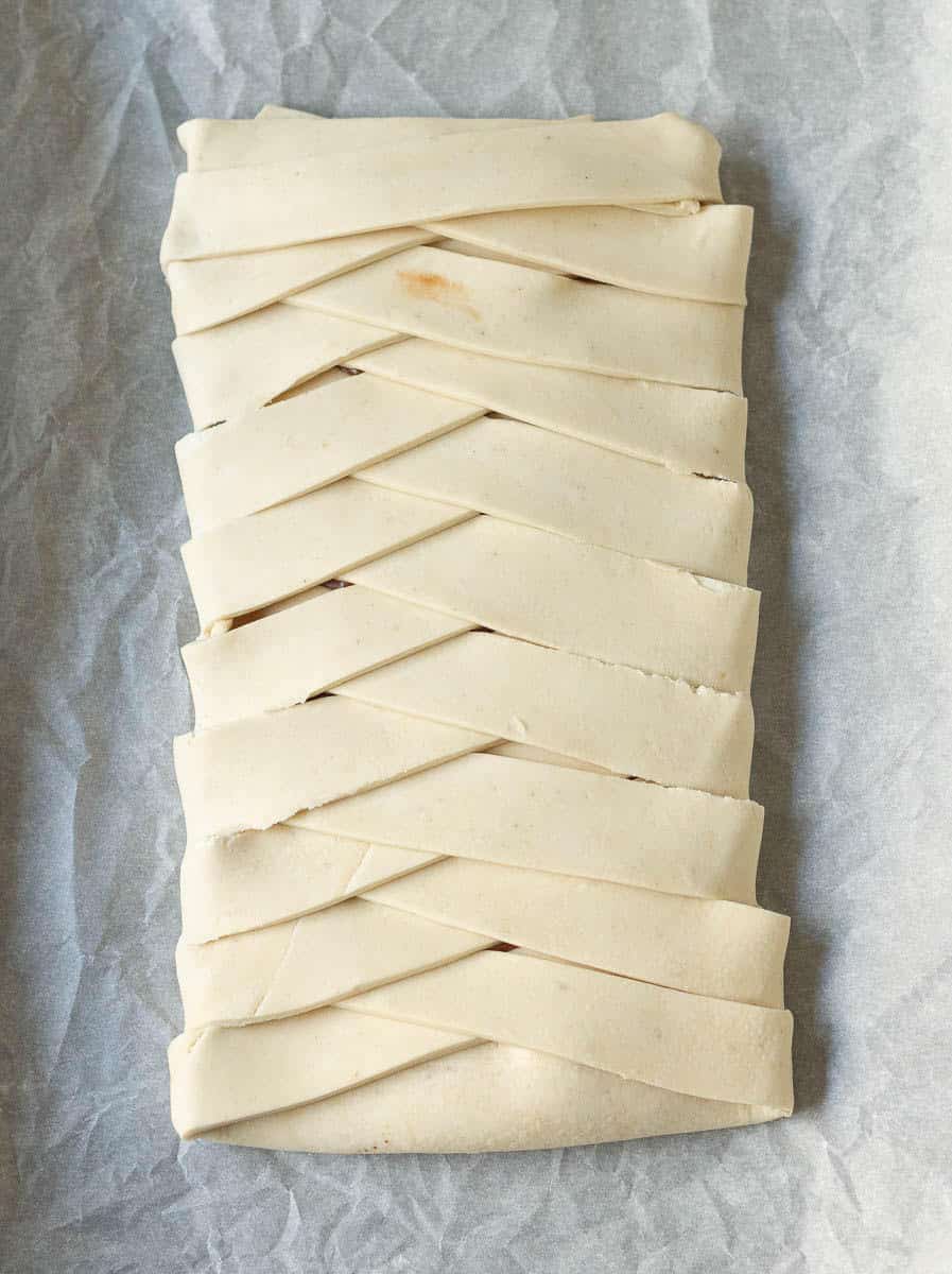 Pastry braid on parchment paper.