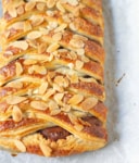 Chocolate puff pastry braid on parchment paper.