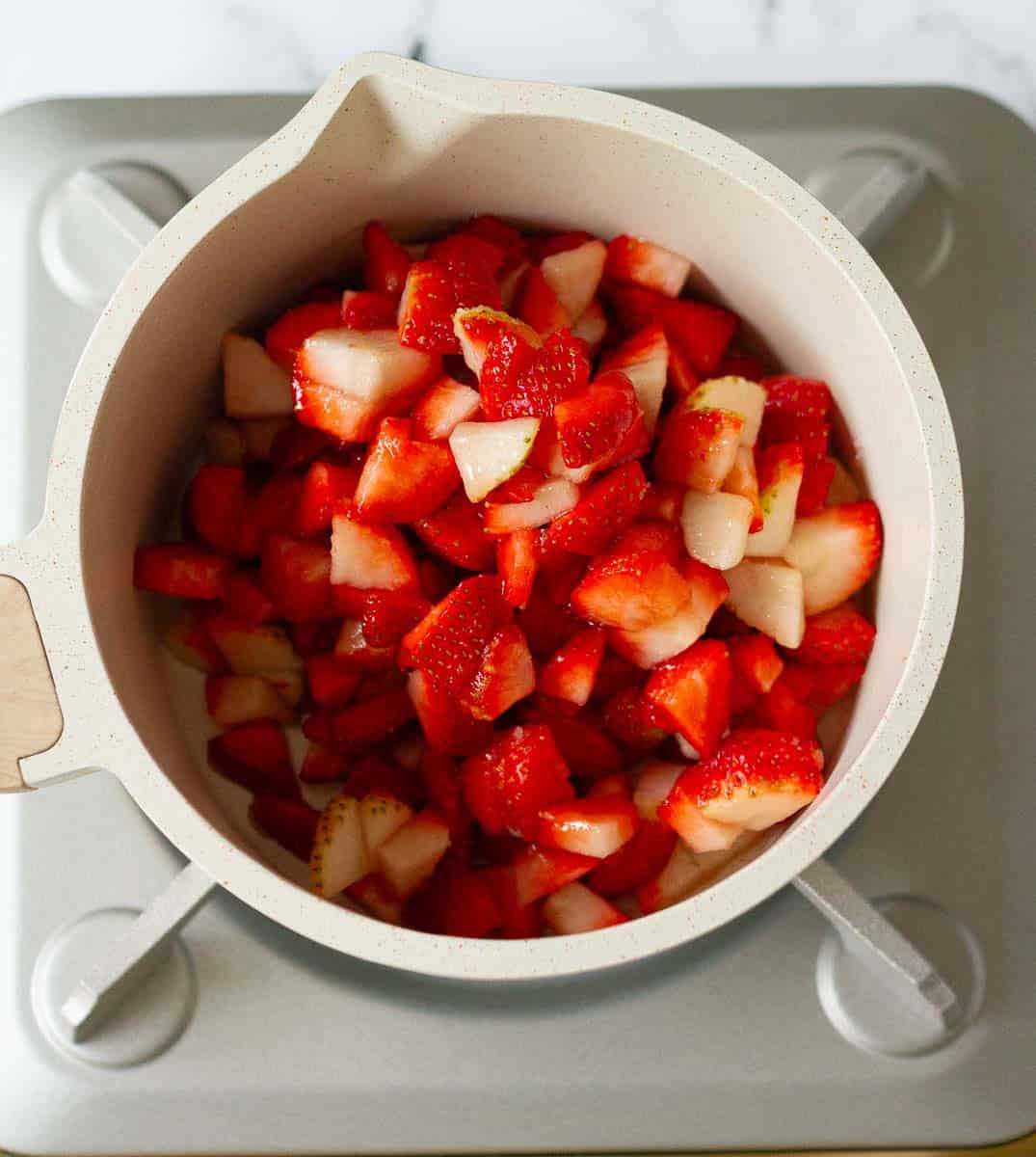 strawberry and sugar mixture in a saucepan.
