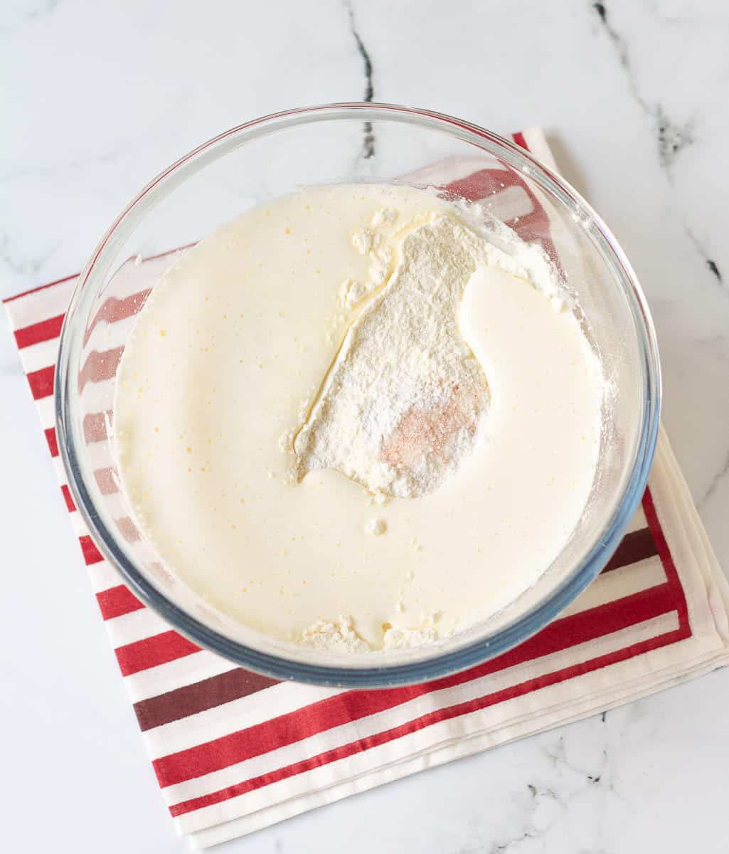 whisking in strawberry syrup, flour, salt and baking powder into the beaten eggs and sugar.
