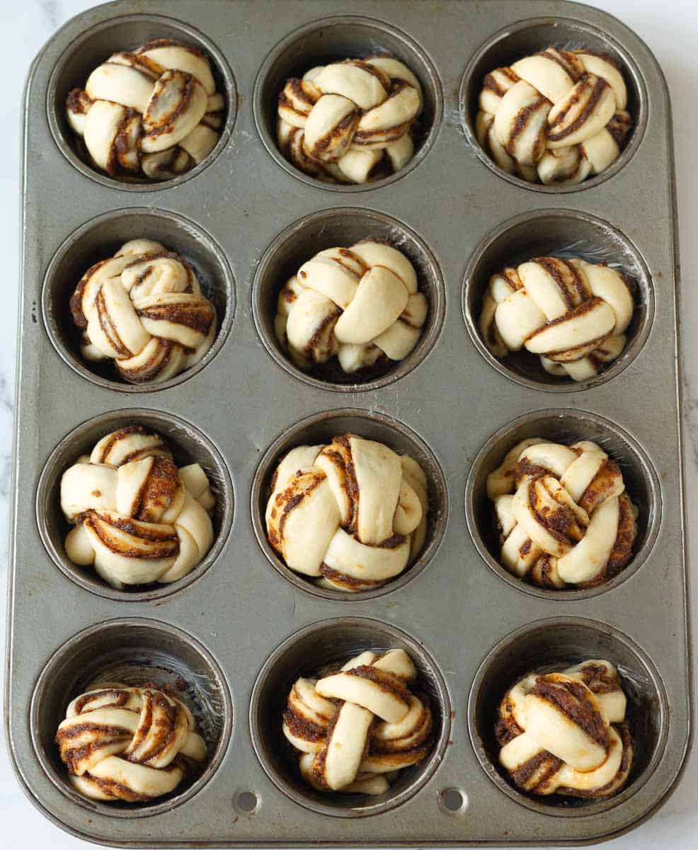 Shaped dough braids in a muffin pan
