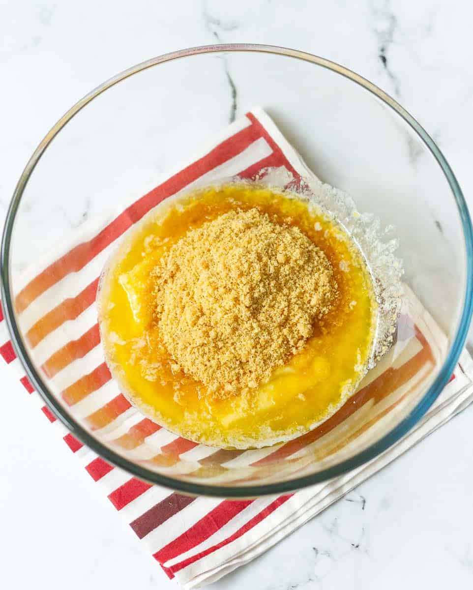 Softened butter and sugar in a glass mixing bowl.