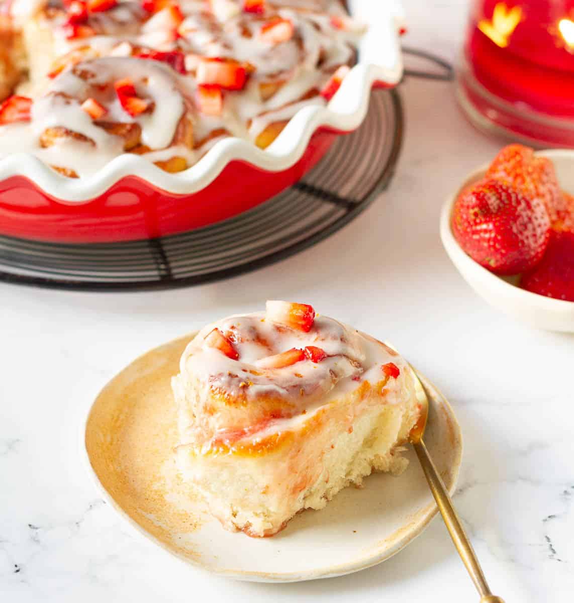 Strawberry roll on a small plate with a fork.