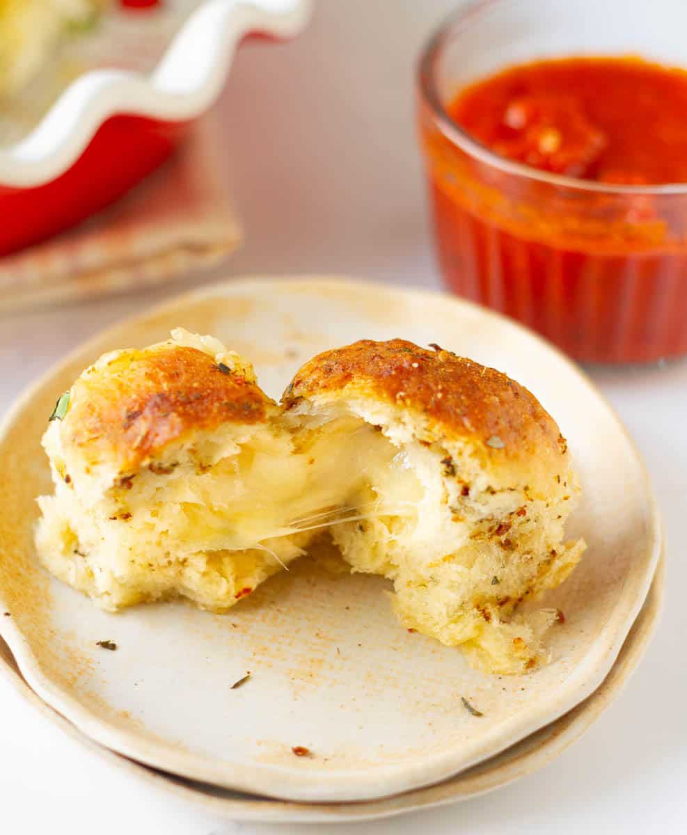 cheesy pizza pull-apart bread split into half to show the cheese pull.