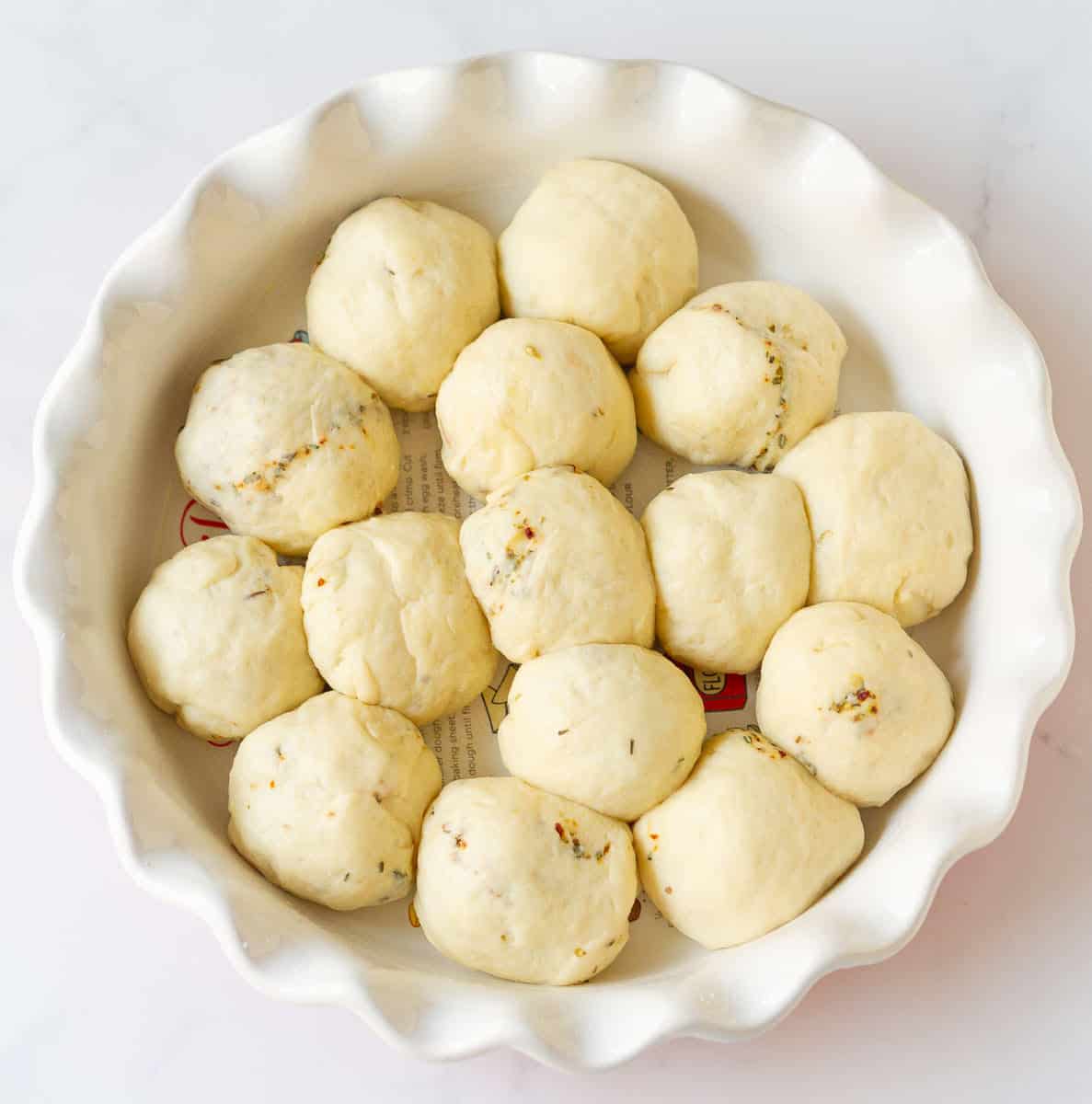 Dough balls in a pan for pizza pull-apart bread.