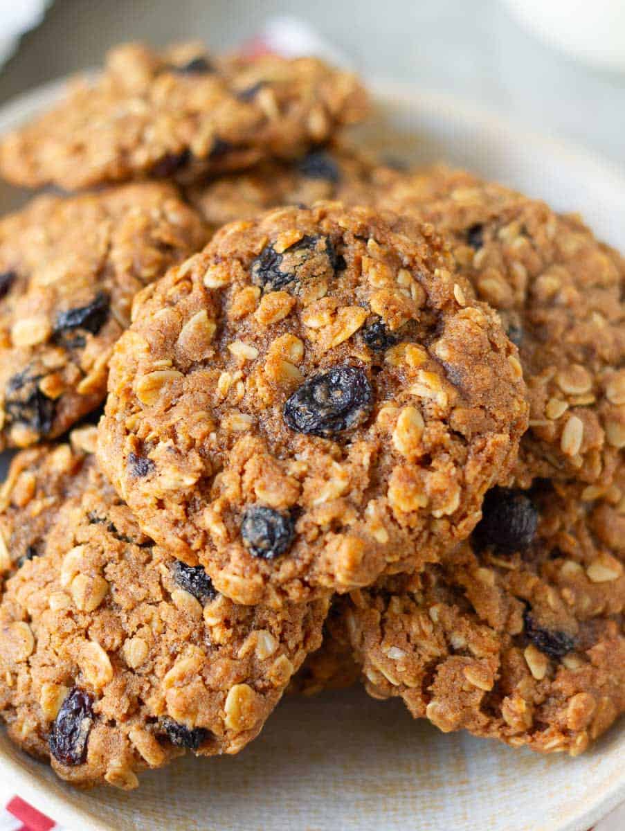Oatmeal Raisin Cookies stacked on a plate.