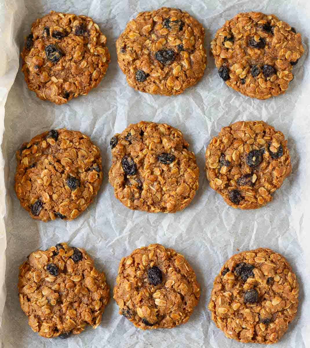 baked oatmeal raisin cookies on parchment paper.