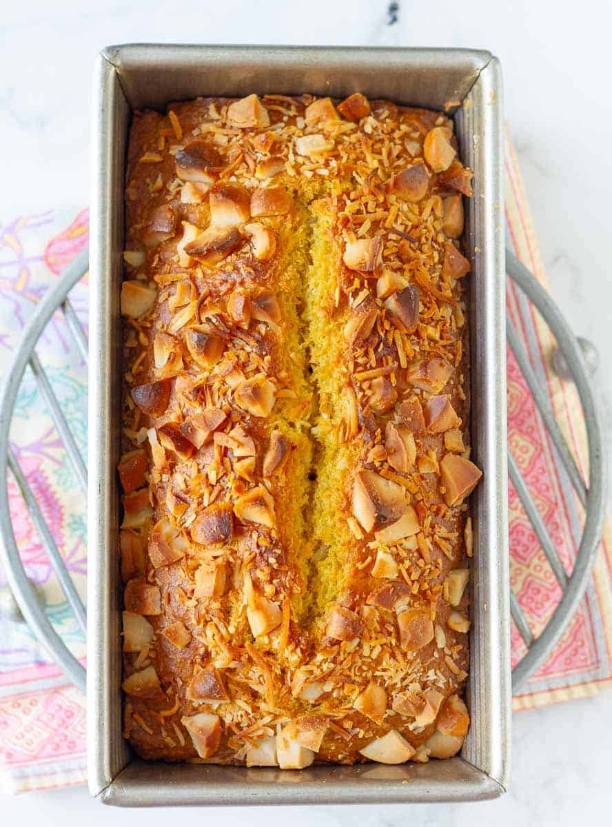 Baked mango bread in a loaf tin.