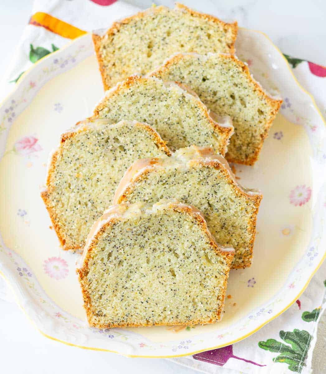Sliced poppyseed bread on a platter.