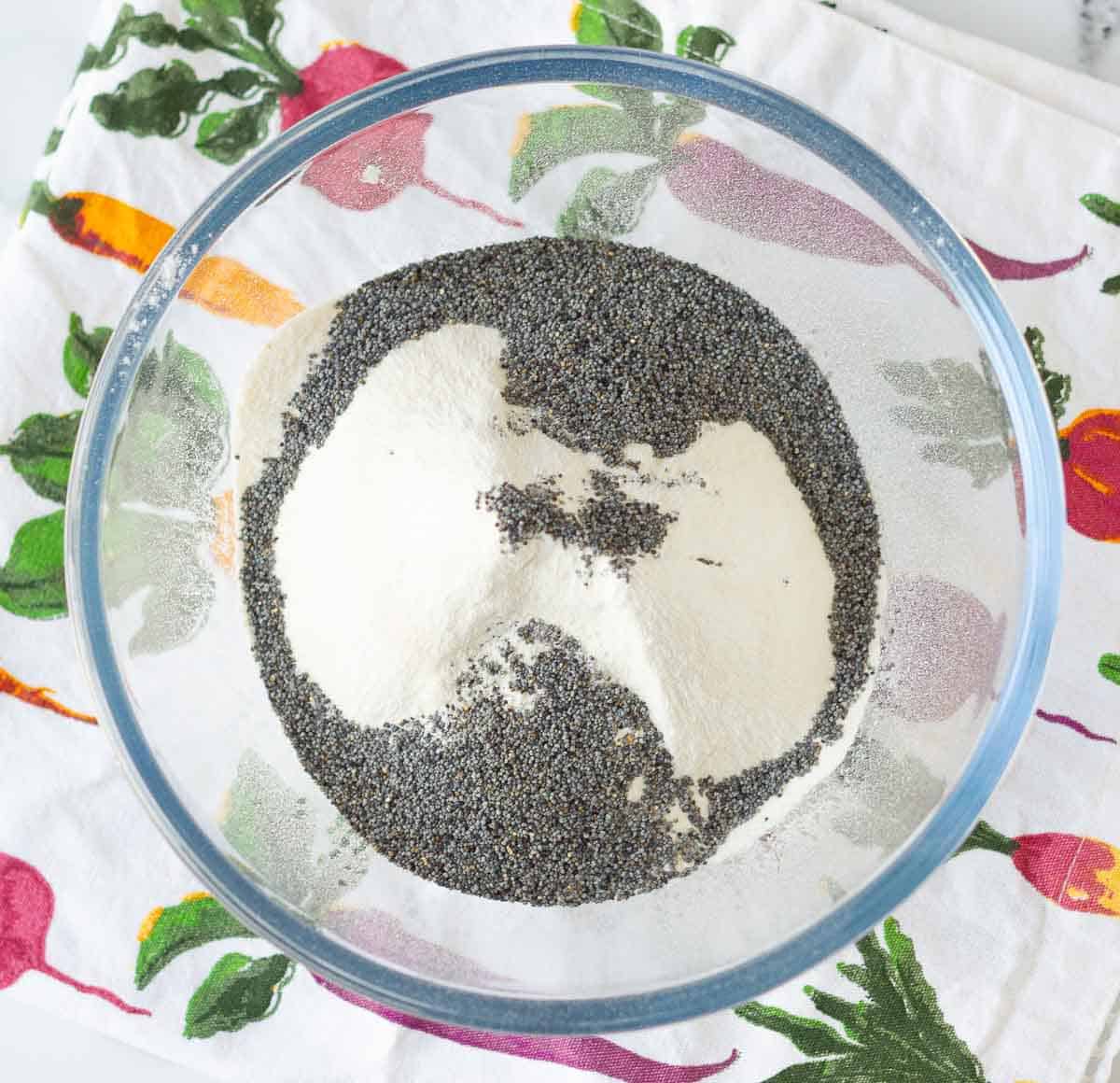 poppy seeds with the dry ingredients for lemon poppy seed bread.