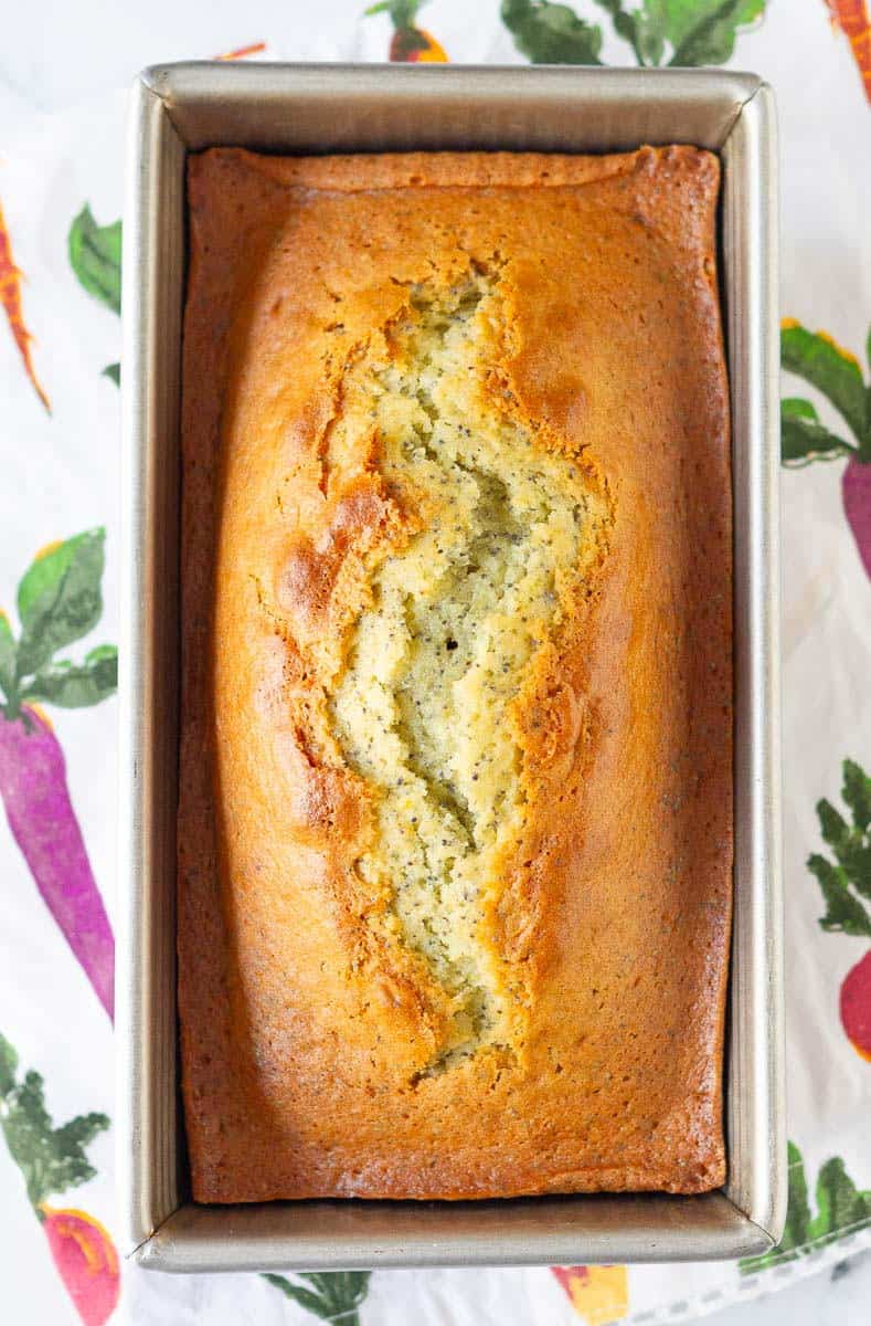 baked lemon poppy seed bread in a loaf pan.