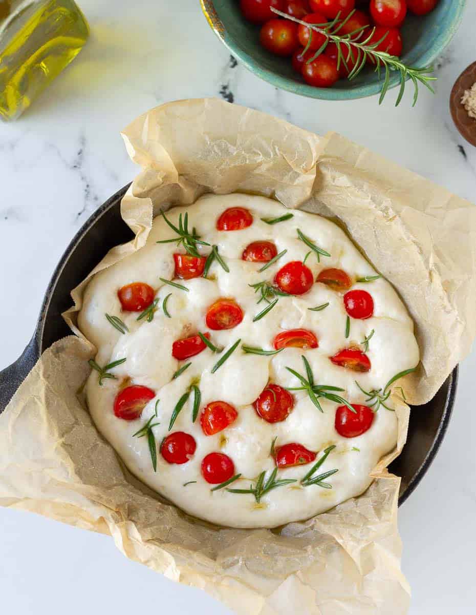 mini focaccia dough topped with cherry tomatoes, rosemary and sea salt