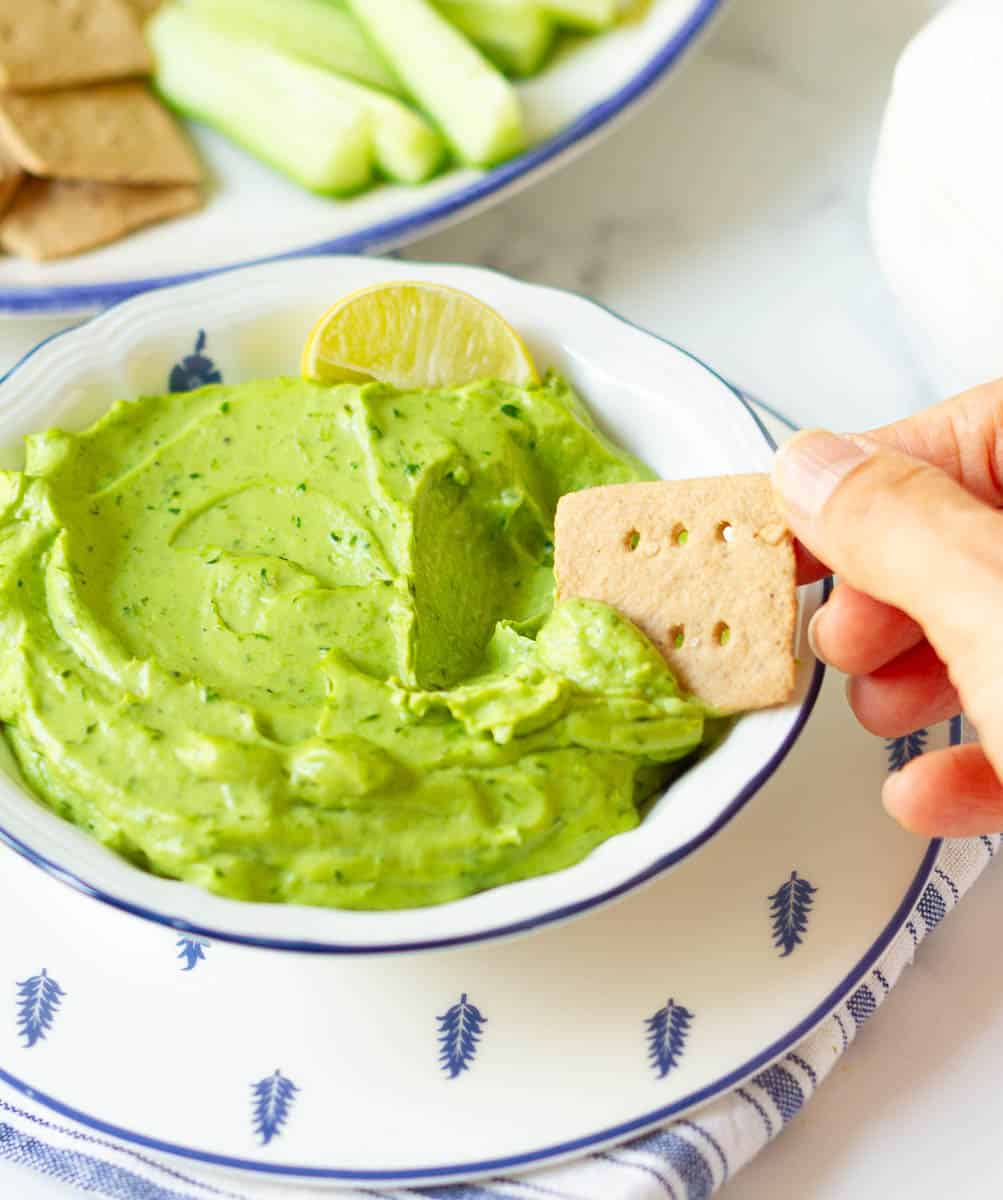 Easy Creamy Avocado Dip on a cracker