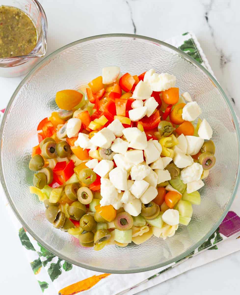 All the ingredients for Italian Tortellini Pasta Salad in a glass bowl