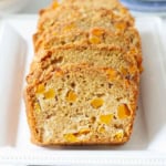 Sliced peach bread on a white platter.