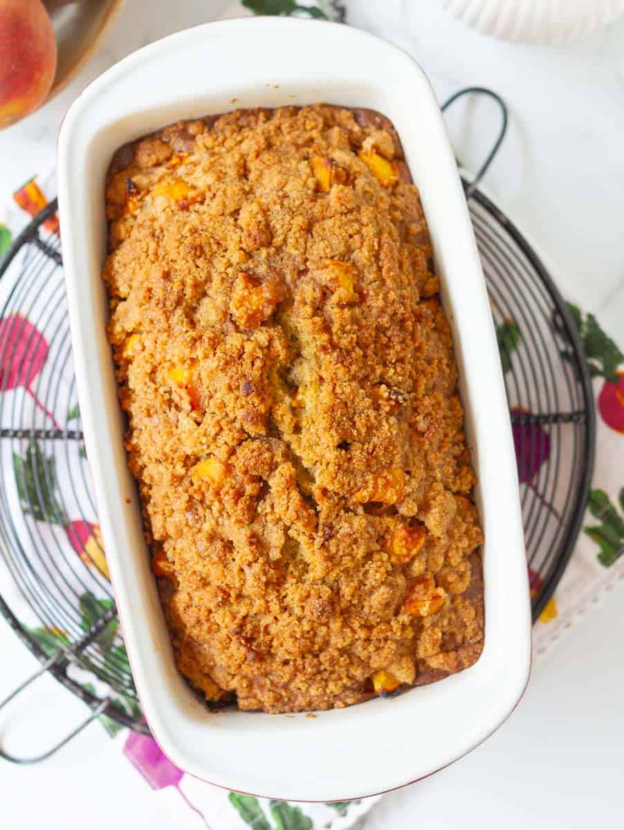 Baked peach bread with streusel in a loaf pan.