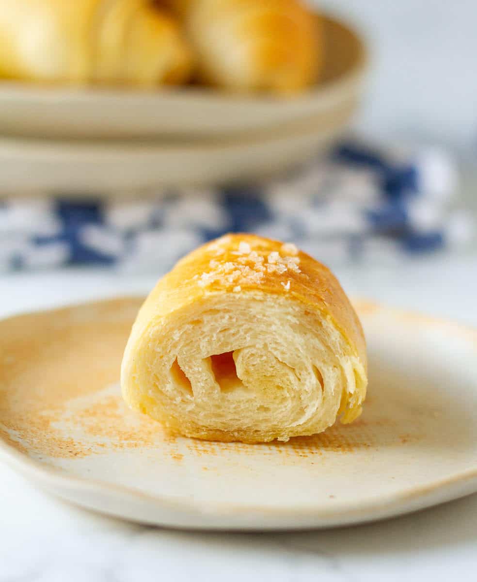 Bread roll cut in half to show the cross-section.