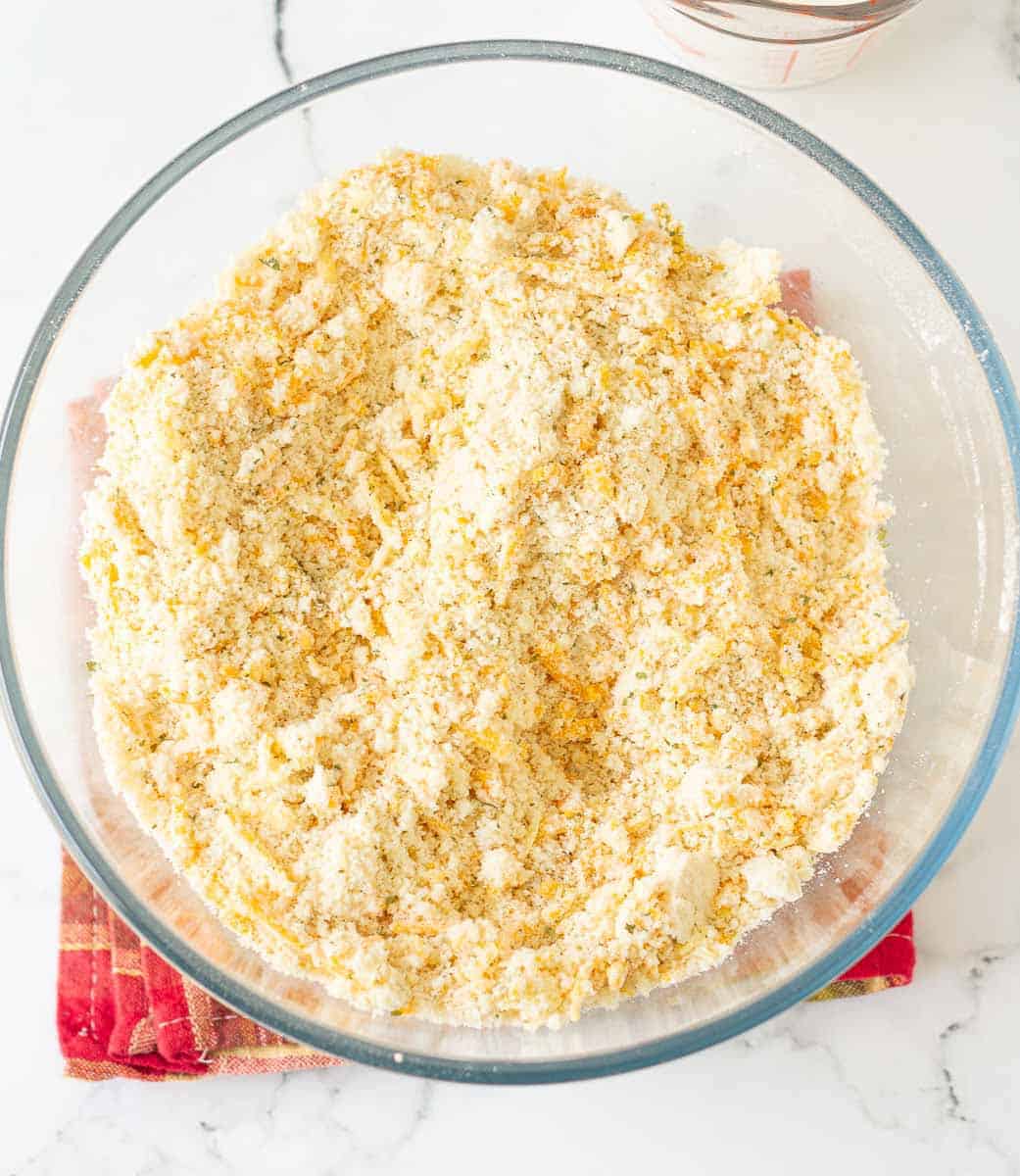 shredded cheese mixed into the butter and dry ingredients in a glass bowl