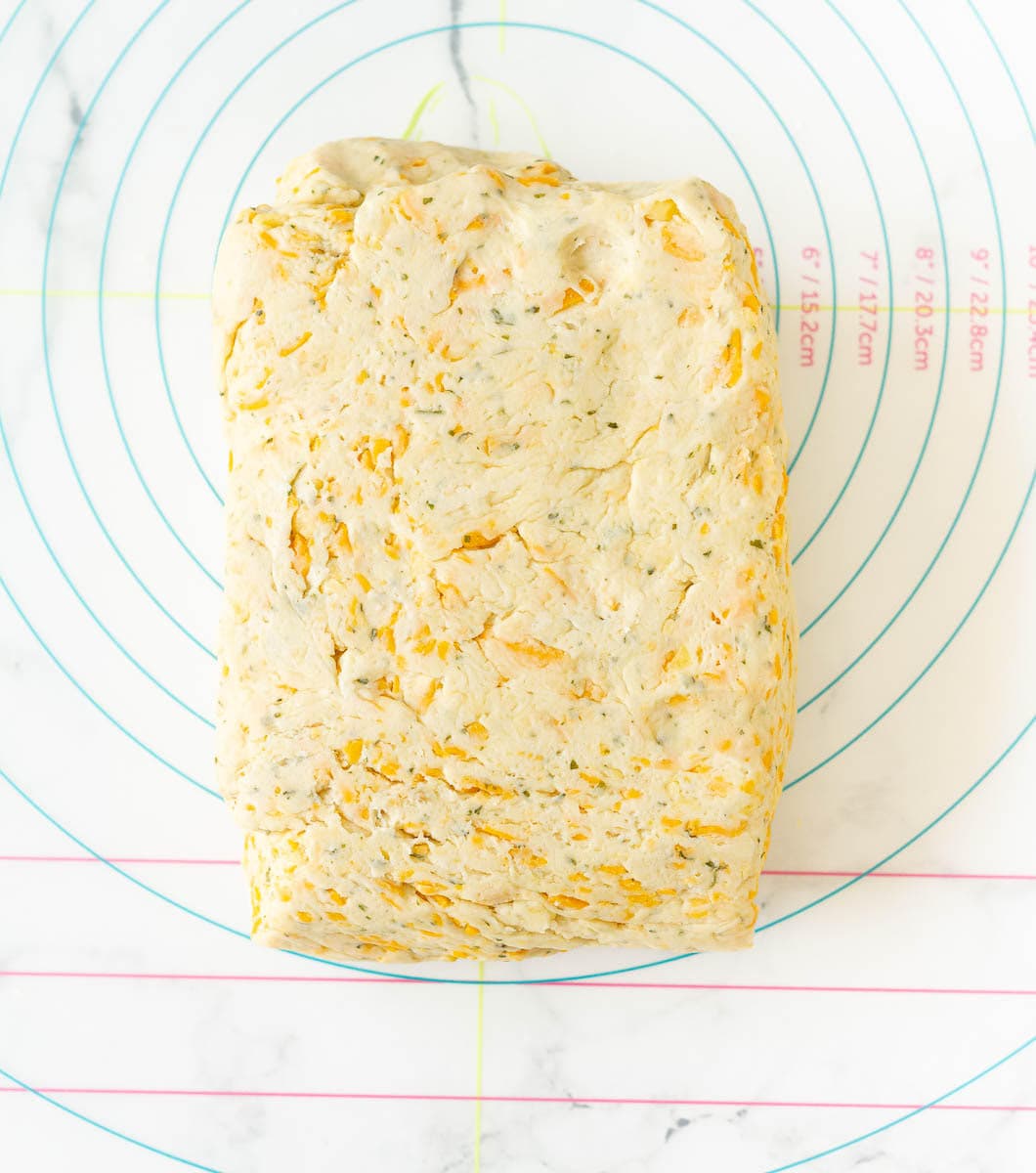 Cheese scone dough formed into a rectangle on a silicon mat