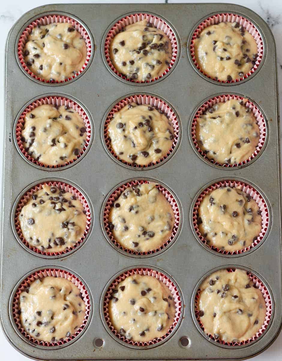 Muffin batter in a muffin tray.