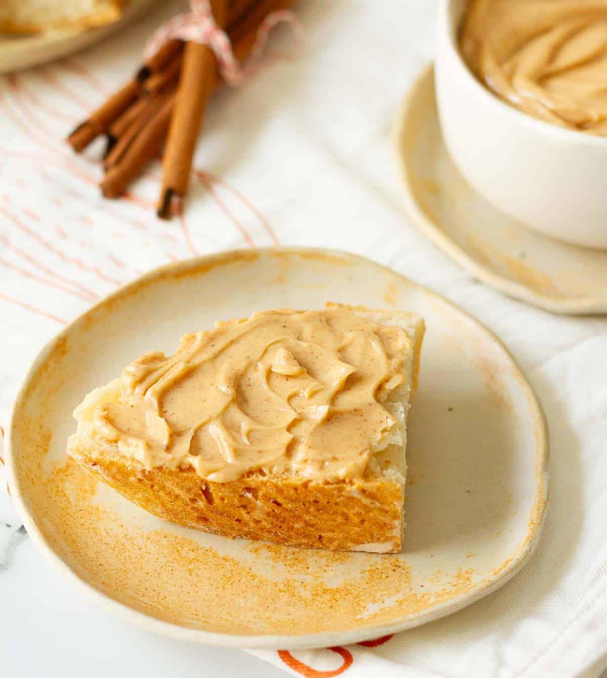 cinnamon butter spread on toast on a small plate.