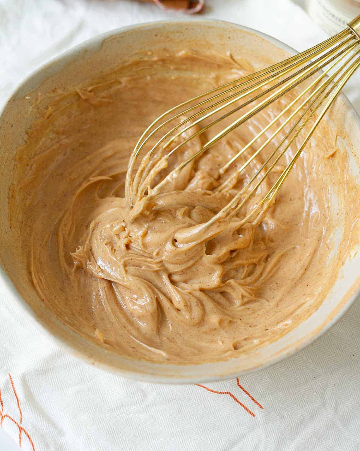 Whisk the ingredients in a bowl with a whisk for making cinnamon honey butter.