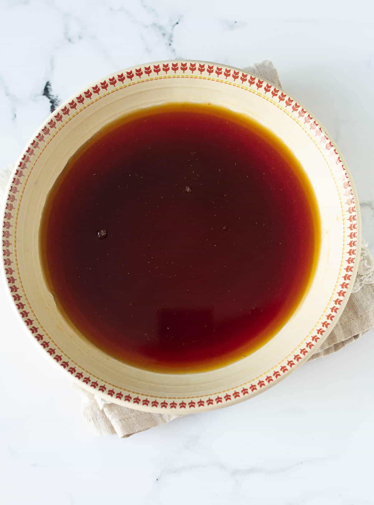Strained black tea in a shallow bowl.