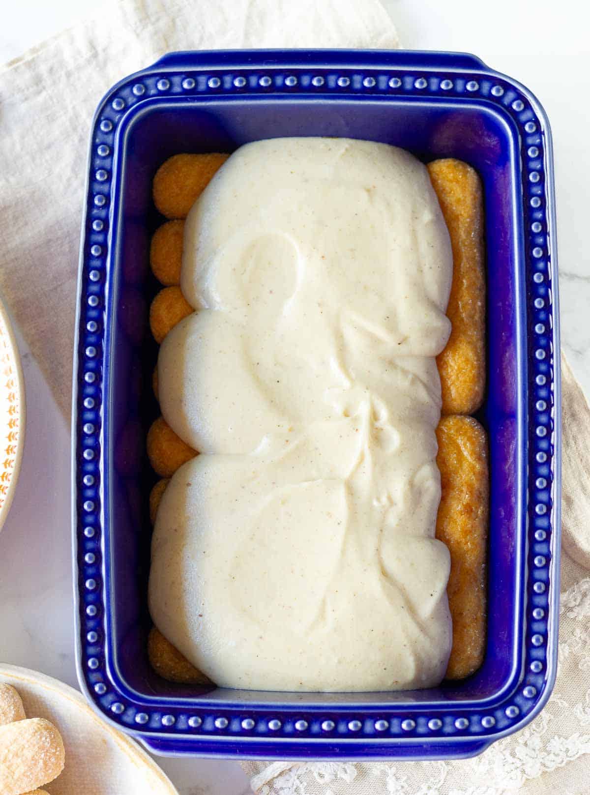 Whipped mascarpone cheese filling on top of ladyfinger cookies.