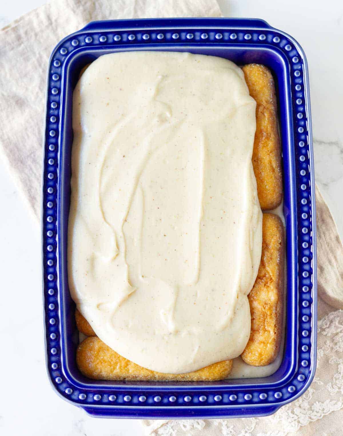 Whipped mascarpone cheese on top of the second layer of ladyfingers.