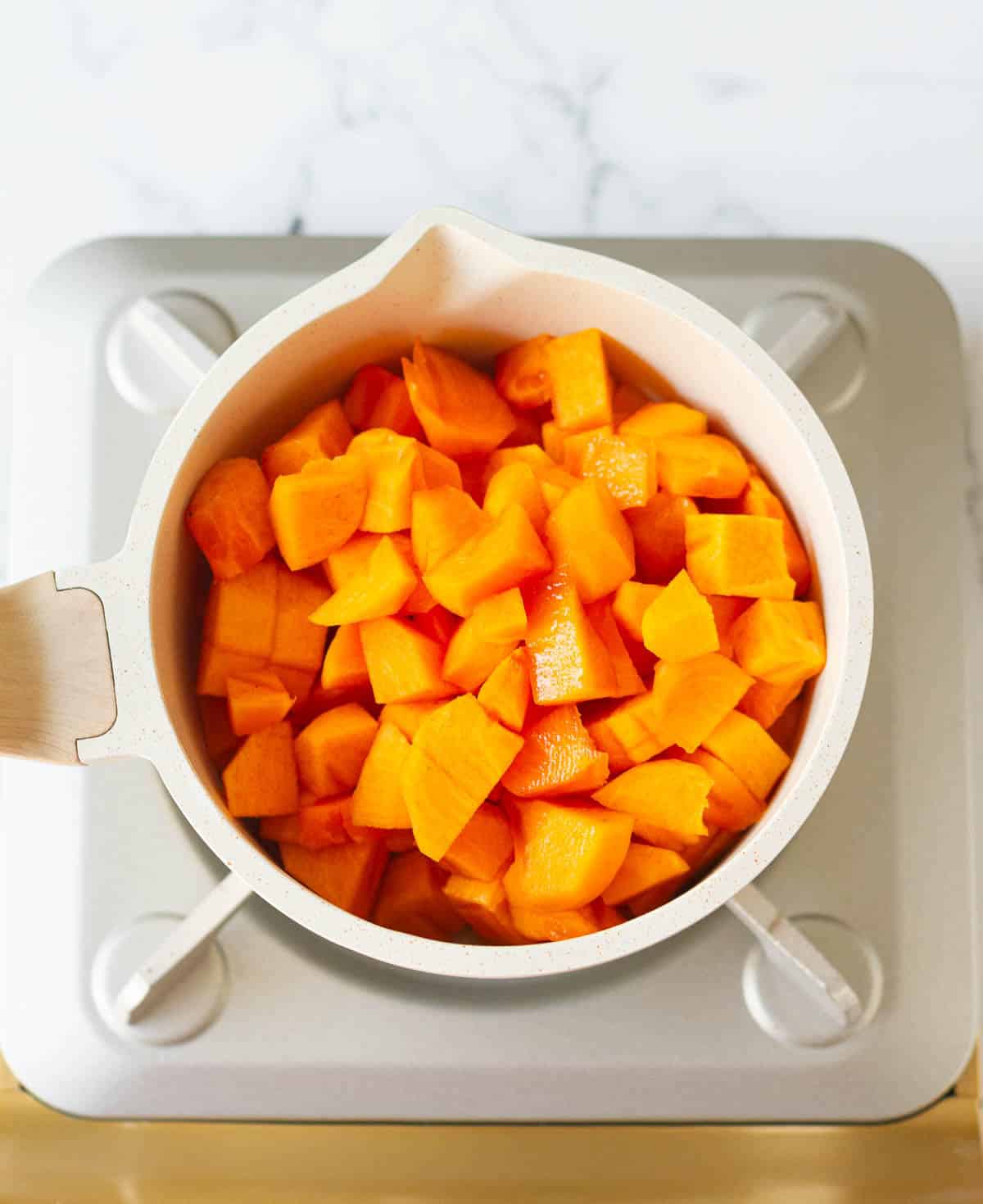peeled and diced persimmons and lemon juice in a saucepan.
