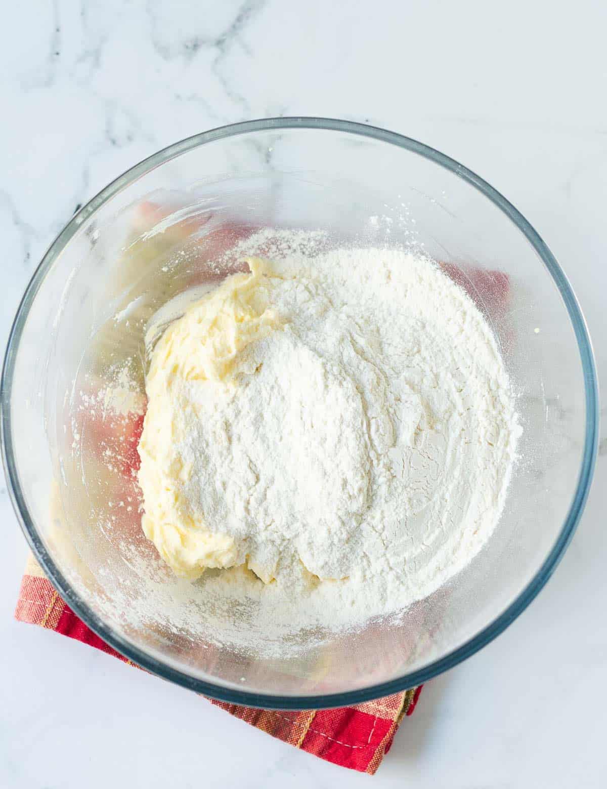 flour on top of the butter and cream cheese mixture.
