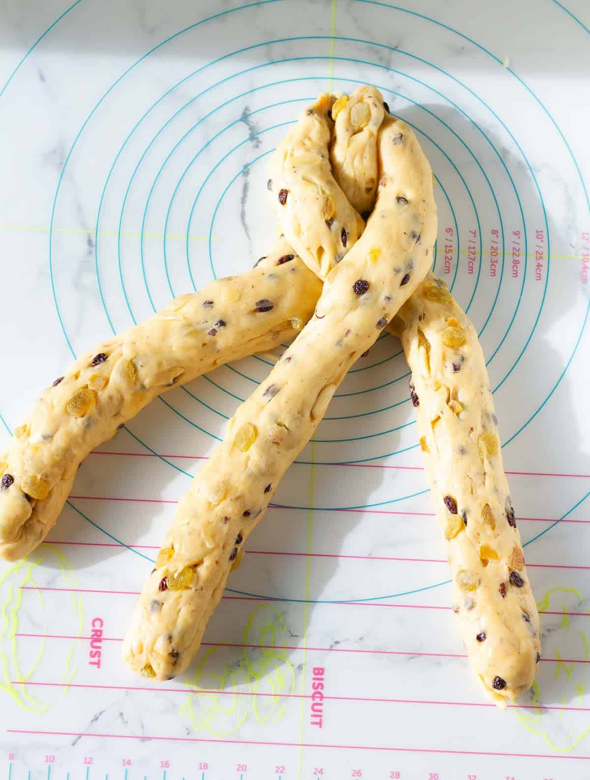 process of braiding 3 dough logs.