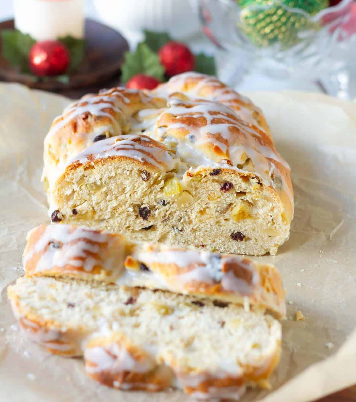 stollen bread loaf with two slices on parchment paper.
