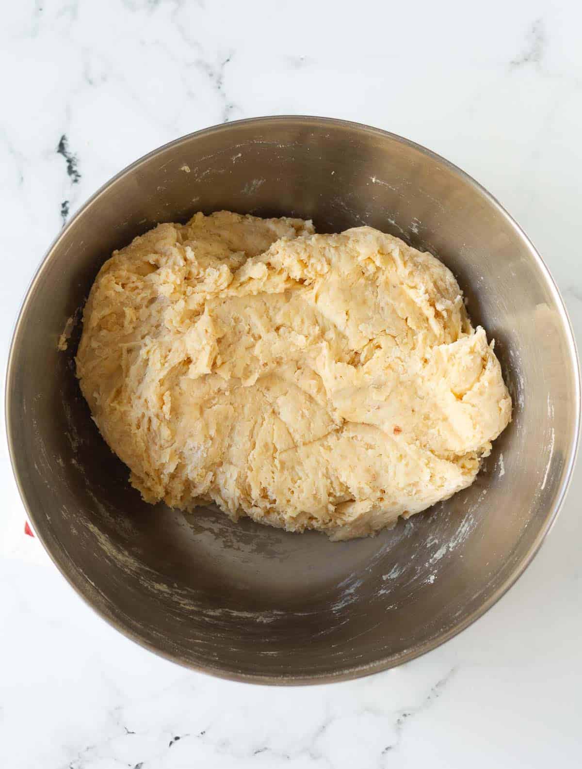all ingredients mixed to make a shaggy dough in a mixing bowl.