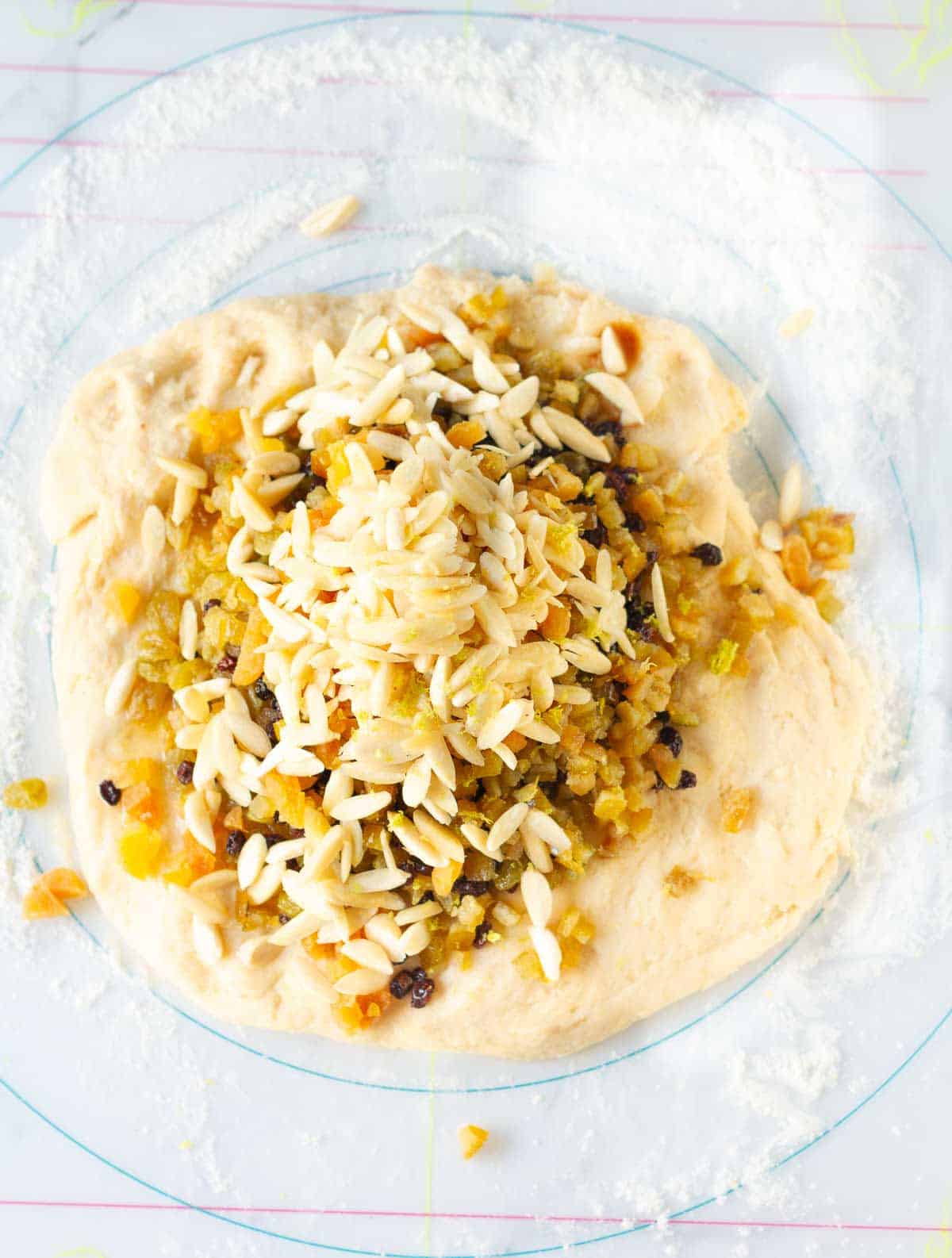 dried fruits and nuts on top of bread dough.