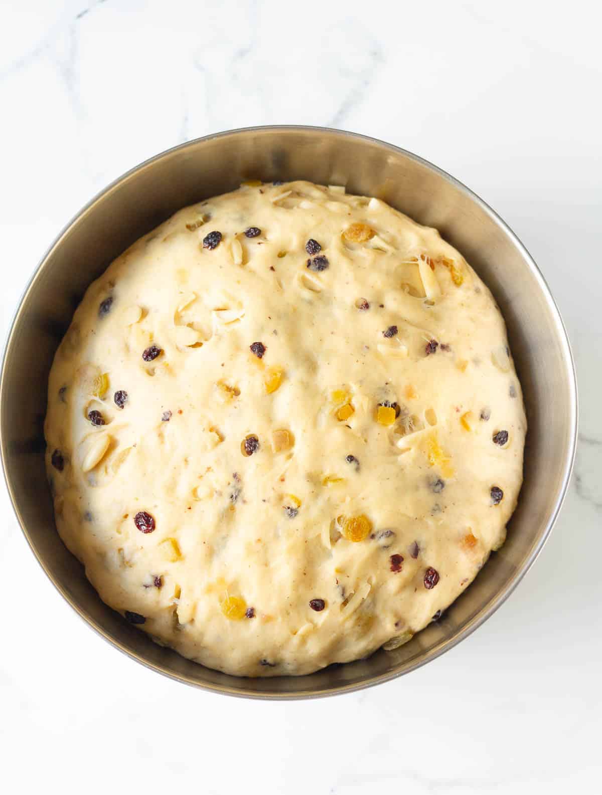 Proofed stollen dough in a mixing bowl.
