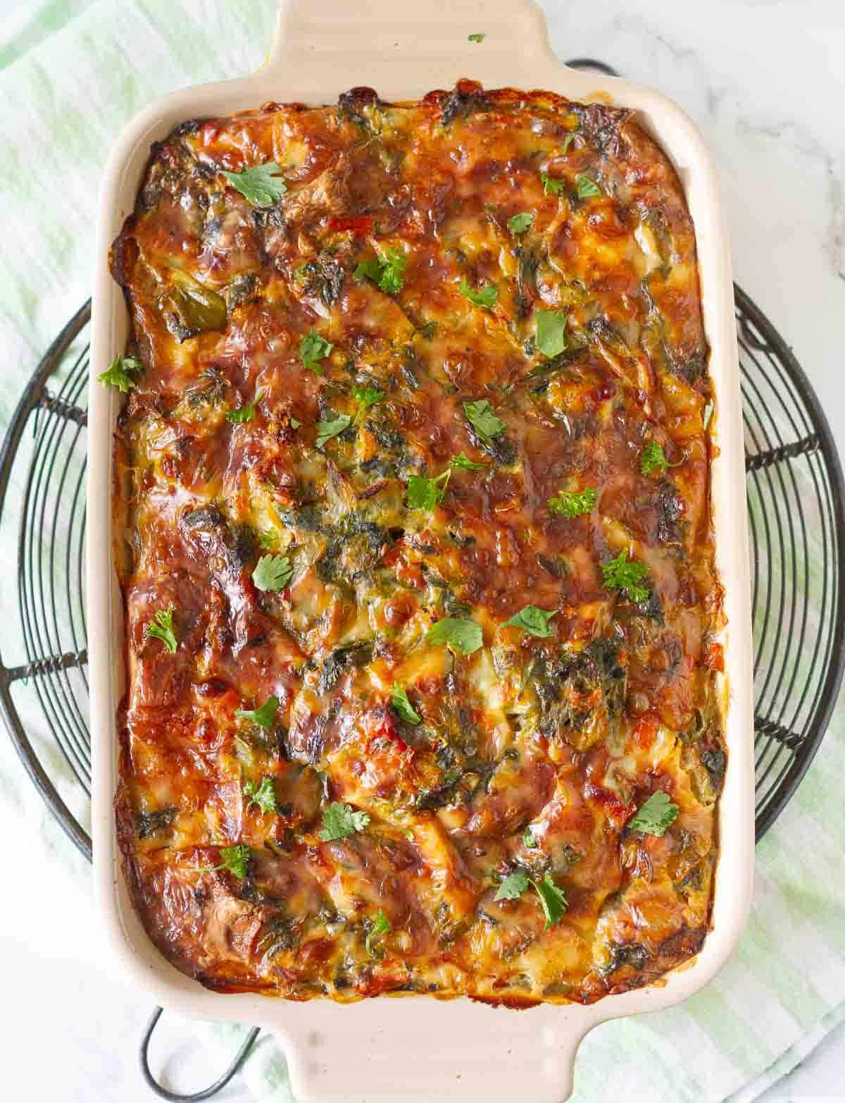 baked veggie breakfast casserole on a metal trivet.